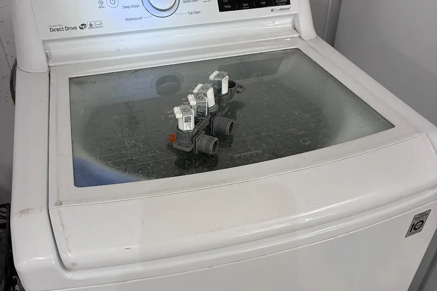 An LG top-load washer, photographed by Plaza Appliance Service Co