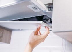 bigstock Man Repairs Hood In The Kitche 257599438 Resized compressed